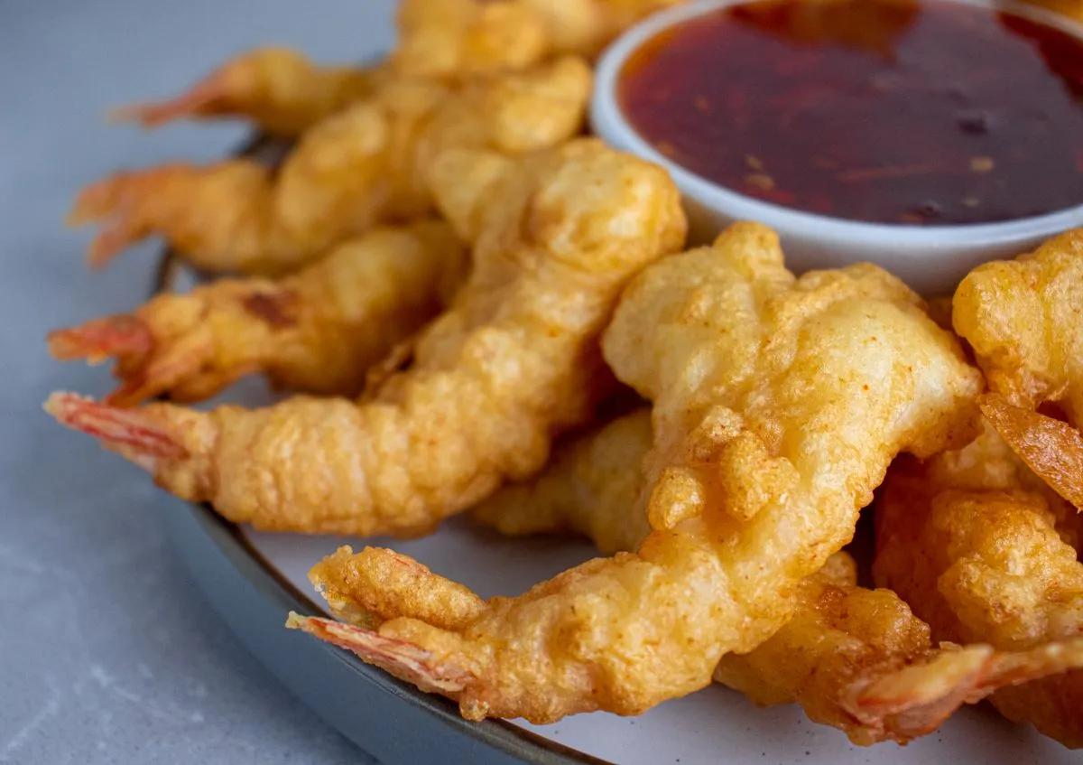 Golden fantail shrimp served around a bowl of sweet and sour sauce